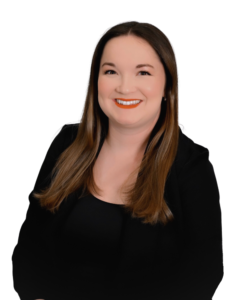 A professional headshot of a woman with long dark hair, wearing a black top and black blazer. She is smiling and facing the camera against a plain white background.