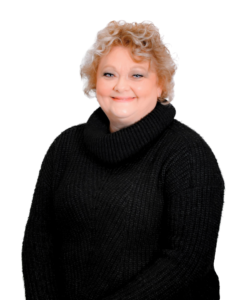 A professional headshot of a woman with curly blonde hair, wearing a black turtleneck sweater. She is smiling and facing the camera against a plain white background.